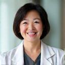 Dr. Lisa Chen, a friendly woman in a white lab coat